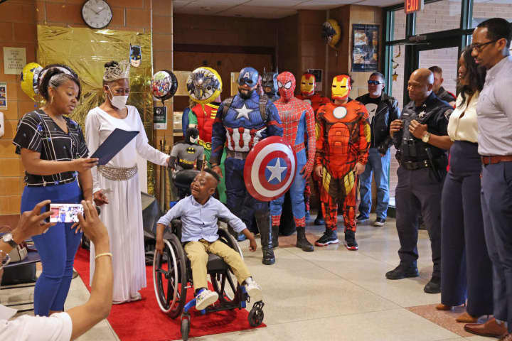 Benjamin Brunson, a second grader at Rebecca M Johnson School, was gifted an accessibility tricycle from Bob &quot;The Bike Man&quot; Charland on Thursday, April 13. Local Police and firefighters dressed up as superheroes for the ceremony.