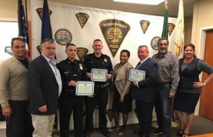 Members of Board of Police Commissioners present three Bridgeport Police officers with the Merit Award for Excellent Arrest. See story for IDs.