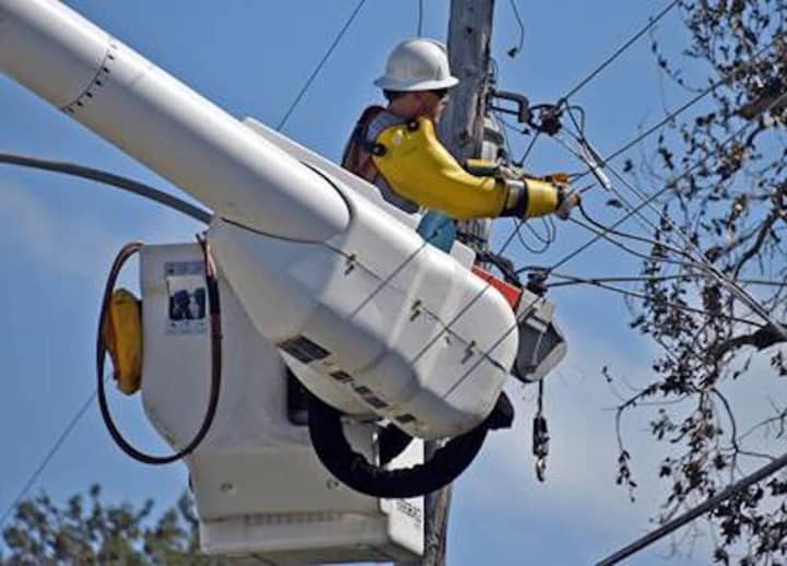 An Eversource utility company worker checking power lines.