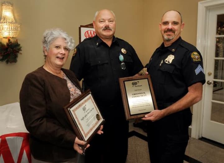AAA Public Affairs Manager Fran Mayko, left, presents, Lt. John Brown, center, and Sgt. John Slusarz with a Gold Award. Officer Loria could not attend the lunch.