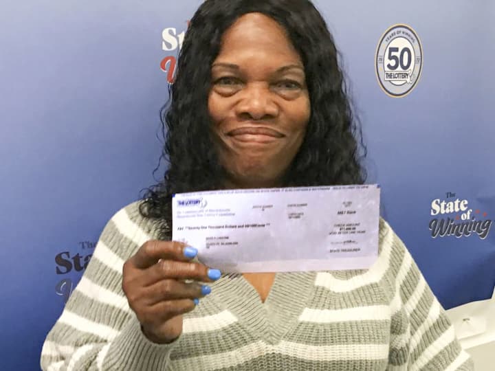 Maria Cherisme, of Randolph, won a $100,000 Mass Cash grand prize on a free Quic Pic ticket she received as part of a Massachusetts State Lottery promotion.