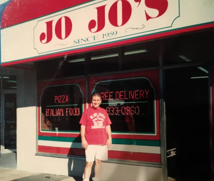 Junior stands in front of JoJo&#x27;s in the earlier years, before changing the storefront.