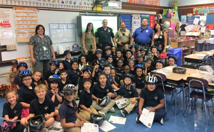 Garfield police officers brought helmets to the youngsters in the second-grade classes of Wioletta Zagorski and Tara Varna.