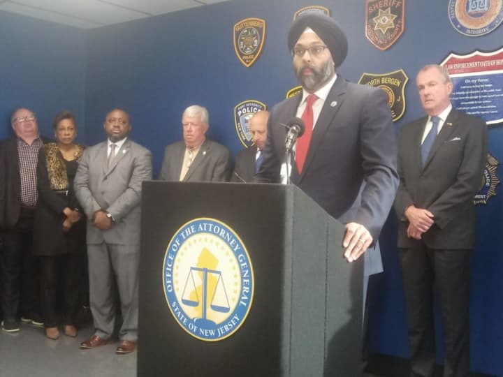 New Jersey Attorney General Gurbir S. Grewal addresses the public, backed by state, local and federal law enforcement officials.