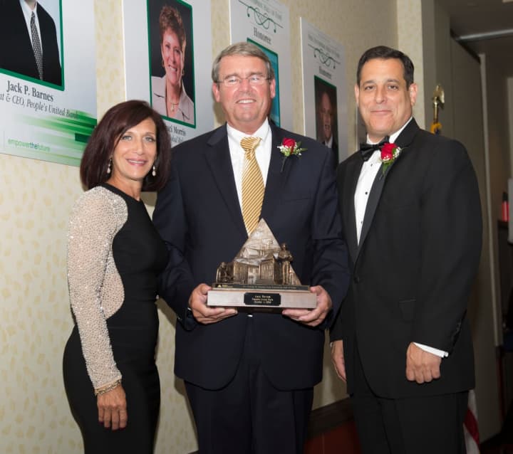 Bernadine Venditto, president of Junior Achievement of Western CT, and board member Philip Palmieri, right, present an award to Jack Barnes, CEO and President of People&#x27;s United Bank.