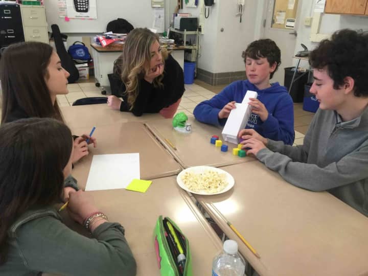 Bronxville Middle School students are shown in math class using popcorn to figure out formulas.