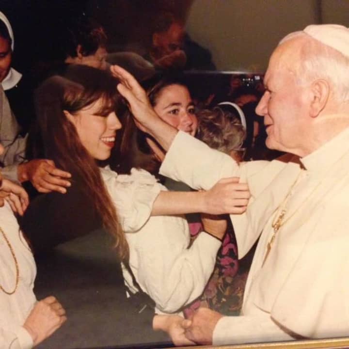 Katherine Tucker at Pope John Paul II. He is holding her hand while bestowing a blessing. 