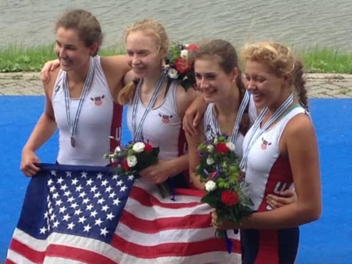 Kelsey McGinley, left, of Westport celebrates with teammates after winning a bronze medal at the World Junior Championships.