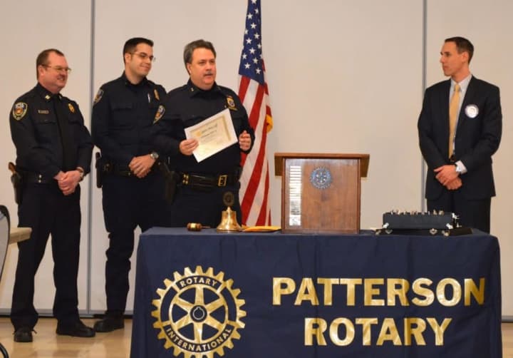 Ken Ross, Chief of the Putnam County SPCA, accepts a donation from the Rotary Club in Patterson with officers Ken Ross III, his son, and Doug MacCrae.