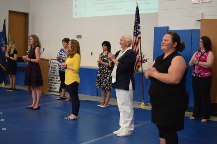 Staff at Pines Bridge School sing at the recent graduation ceremony.