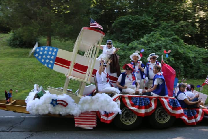 The New Fairfield Board of Selectmen are shown aboard a patriotic float in the town&#x27;s July 4th parade.
