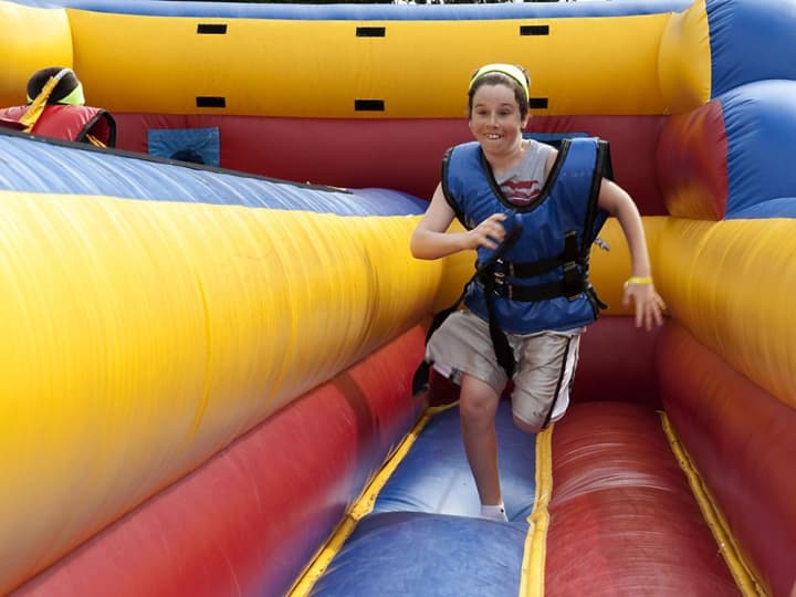 A happy guest bounces around on an inflatable during Little Ferry&#x27;s 2012 Family Fun Day.