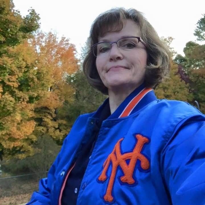 Elizabeth Healy of Danbury sports her Mets jacket with pride. The Mets face off against the Kansas City Royals on Tuesday night in the World Series opener. 