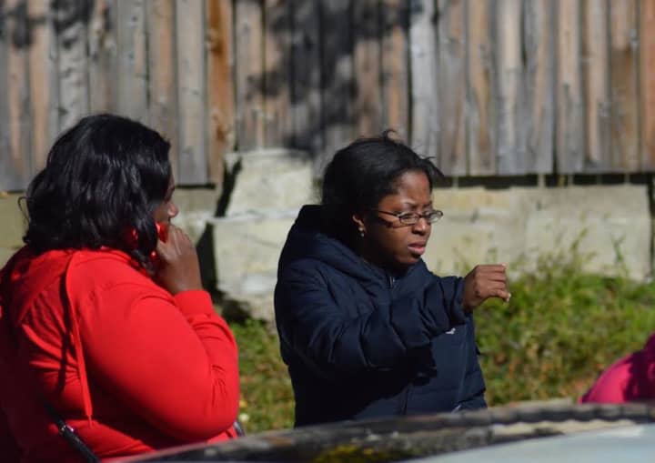 A daughter of Maxine Gooden returns to Lione Park in Stamford on Tuesday. On Monday night, she was at the park with her mother, who was fatally shot. 