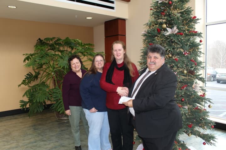 PHC Medical Staff President Dr. Michael Nesheiwat delivers donations to, from left, Gail Pease of the Brewster Emergency Shelter Partnership, Marion Swarm-Becker of the Patterson Food Pantry and Andrea Bach of Philipstown Food Pantry.