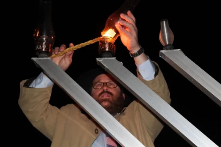 Rabbi Levi Stone lights the menorah at a 2014 Westport celebration.