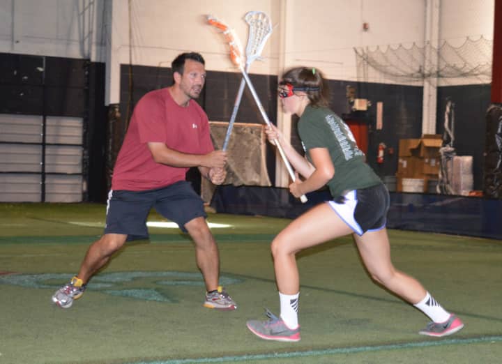 Northern Highlands Varsity Lacrosse Coach Mike Menzella puts some pressure on an athlete during tryouts for X-Treme Lax Factory&#x27;s Club Team on Sept. 20.