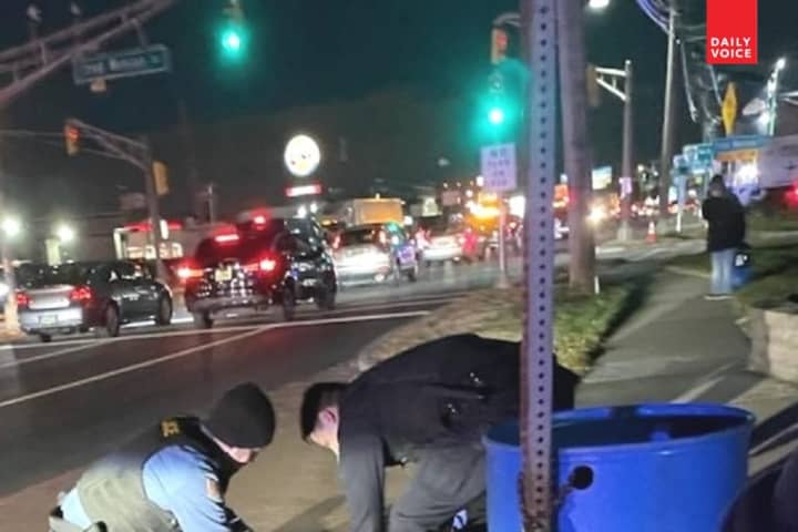 The first officers on the scene tend to the mortally injured pedestrian on eastbound Route 46 in Teterboro.
