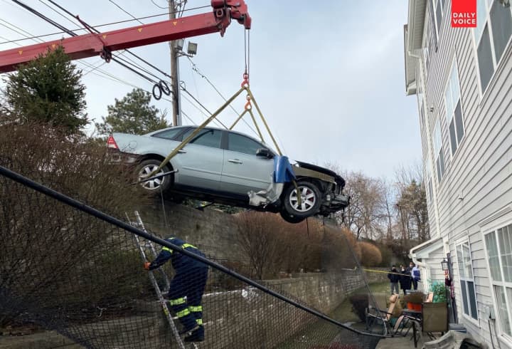 Brookside Towing removes the Mercury sedan outside the Clifton townhouse off the Garden State Parkway.