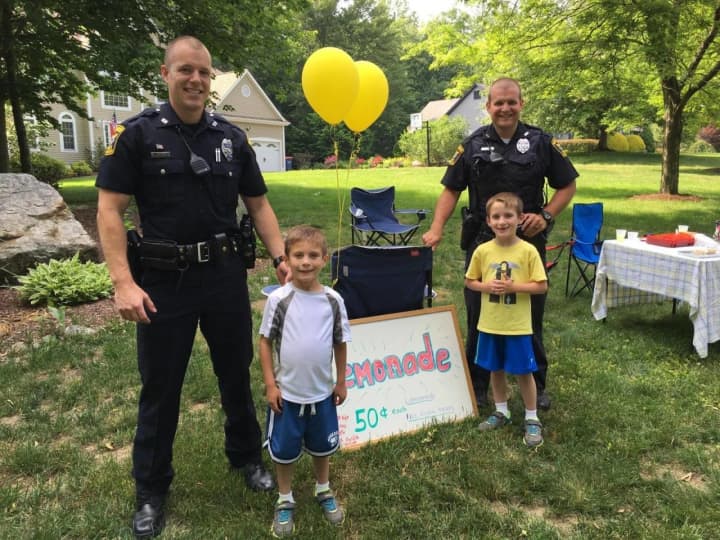 These Monroe police officers stopped by this lemonade stand in Monroe.