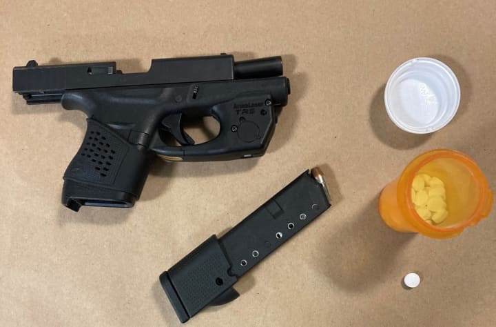A 20-year-old man was charged after police said he was found in possession of a loaded pistol and oxycodone pills during a traffic stop on Long Island.