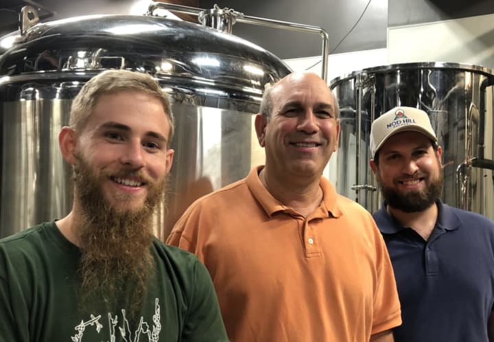 Head Brewer Kyle Acenowr, left, with Founders Rob and David Kaye (middle and right) of Nod Hill Bewery pose next to their new fermentation tanks.
