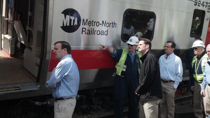 U.S. Sen. Chris Murphy, U.S. Rep. Jim Himes and other officials check the damage to the Metro-North trains. 