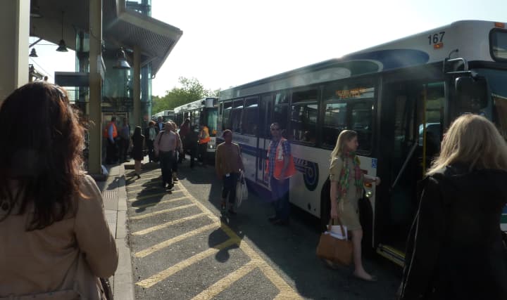Out-of-town commuters board shuttle buses outside Westport&#x27;s Saugatuck Metro-North Railroad station Monday evening. 