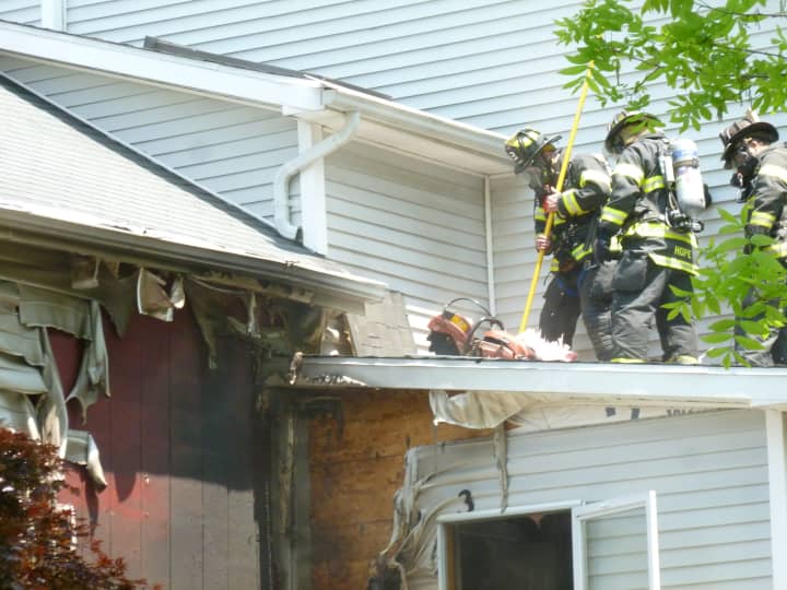 Norwalk firefighters extinguish a blaze at 43 East Ave. in Norwalk Tuesday. No injuries were reported.