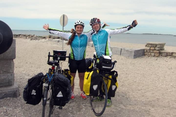 Westport resident Alec Bernard, right, and friend Allie Wills kick off their more than 3,000 mile charity bike journey from Westport&#x27;s Compo Beach last Friday. 