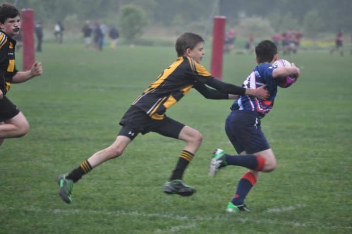 Redding&#x27;s William Carello goes in for a tackle against Union, N.J. for the Aspetuck Valley Rugby Football Club last week. 
