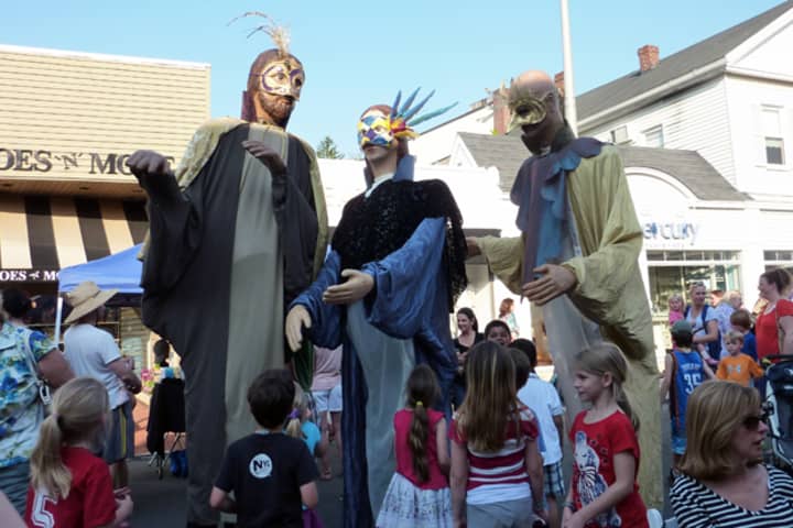 Large papier-mache figures entertain party-goers on Main Street in Westport Thursday night during the third annual Art About Town street party.