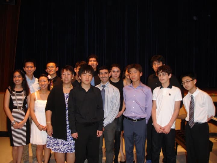 Edgemont High School student musicians with Nicholas Kim, in black. Marsha Tom, Director of Big Brothers Big Sisters of FSW and John Catoliato, Instrument Music teacher on either side of Kim.
