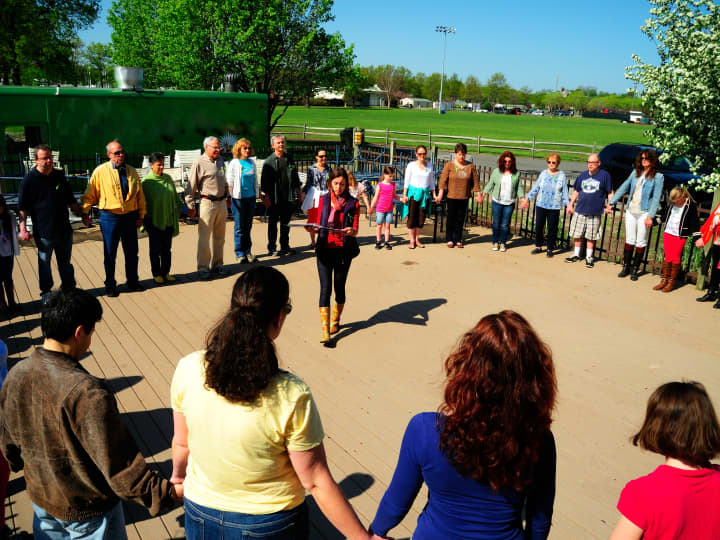 Hilde Friderichs (center of circle) leads the first Circles of Peace event on Mother&#x27;s Day. 