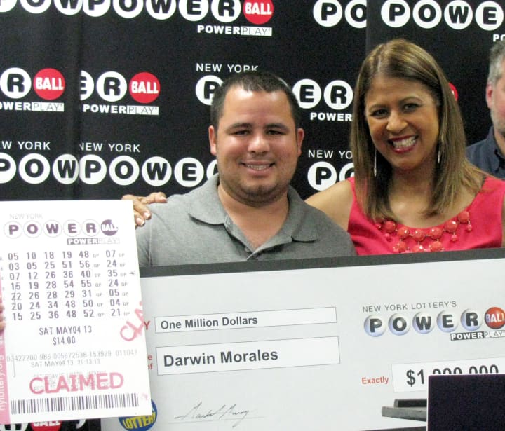 Somers resident Darwin Morales received an oversized check Tuesday in Fishkill from New York Lottery&#x27;s Yolanda Vega for $1 million.