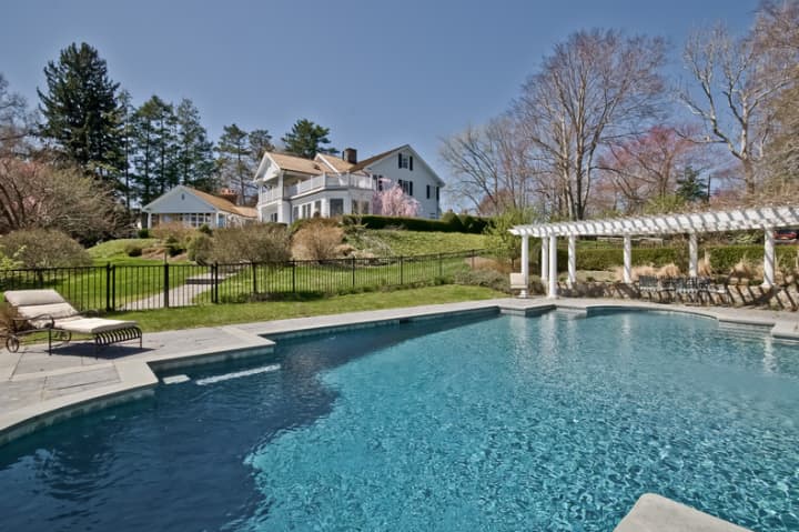 This home at 215 Greenfield Hill Road, listed by Melanie Smith, has a pool situated away from the house.