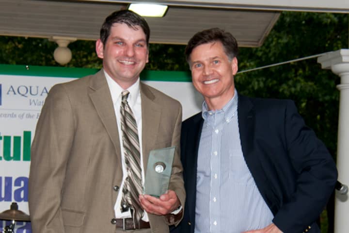 Staples High School teacher Michael Aitkenhead receives his Aquarion Environmental Champion award from state Department of Energy and Environmental Protection Commissioner Daniel Esty Saturday.