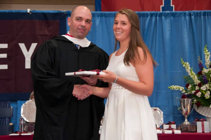 Abigail Hassett of Katonah, who received two awards at Harvey&#x27;s June 6 commencement, the Photography Prize and the Girls&#x27; Athletic Prize, is congratulated by Upper School Head Phil Lazzaro.