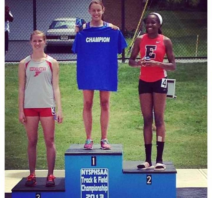 North Salem High School senior Noemi Bechu (c.) took first place in the 200m event at the New York State meet.