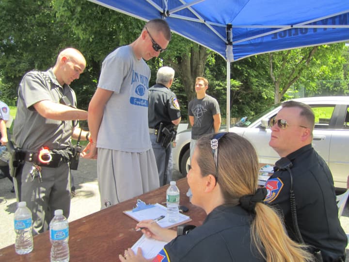 Cortlandt Manor volunteer Dylan Stewart is &quot;arrested and processed&quot; during the annual Westchester County Mutual Aid exercise at Valhalla&#x27;s Westchester Community College. 