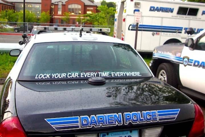 Darien Police say a Norwalk woman who backed into a light pole with a child in her backseat was driving under the influence.