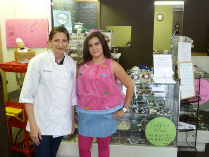 The owner of Chocolations Maria Velente (left) had her employee Yennifer Bayarae dress up like a cupcake for the store&#x27;s one year anniversary. 