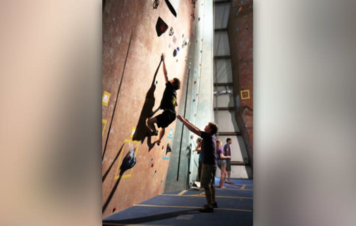 Bryce Viola, a first-year applied mathematics RIT student and 2013 national collegiate bouldering champion, attempts a bouldering route.