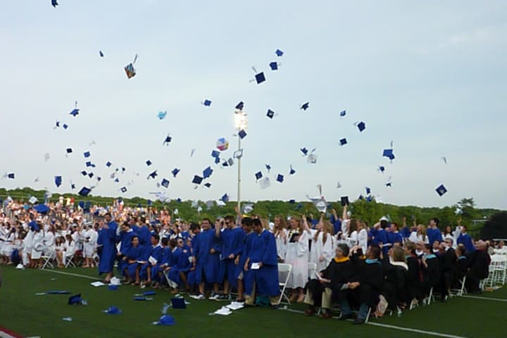 Members of Wilton High School&#x27;s Class of 2013 throw their caps into the air at the close of Saturday&#x27;s graduation ceremony.