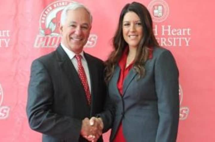 Jessica Mannetti of New Canaan is greeted by Sacred Heart University  Athletic Director Bobby Valentine at a press conference in Fairfield Tuesday.