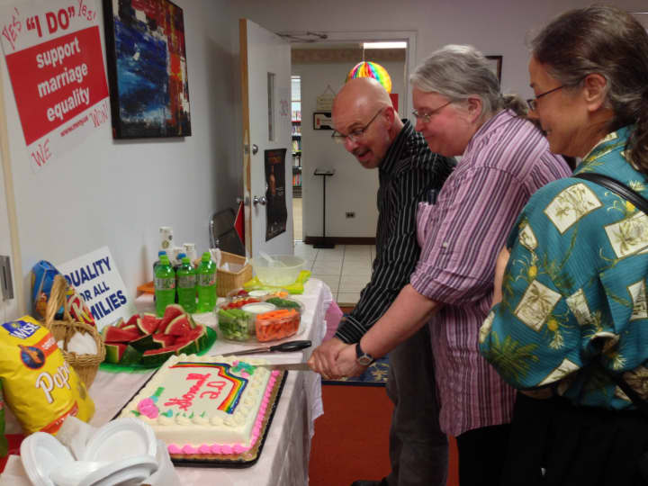 David Juhren joins Karen Carr and her wife Yvette Christofilis (Irvington) in cutting a rainbow cake to celebrate the Supreme Court decisions on DOMA and Prop 8. 