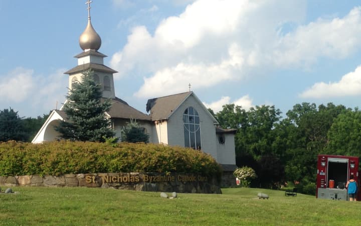 St. Nicholas Church, a landmark on Pembroke Road in Danbury, is heavily damaged after a fire Saturday. The roof behind the onion dome has collapsed. 