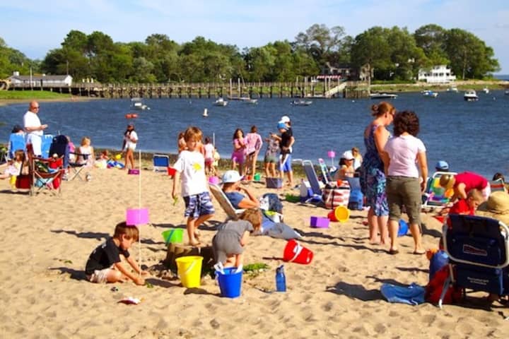 Families relax on a bright, sunny day at Weed Beach in Darien. But the beach exceeds the state&#x27;s daily maximum bacterial standard about 19 percent of the time, according to a recent report. 
