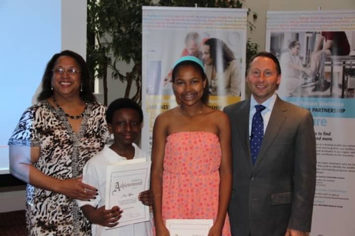 Westchester County Executive Rob Astorino with the winners of the Astorino Challenge in Education, J&#x27;air Myree and Hannah Zamor.