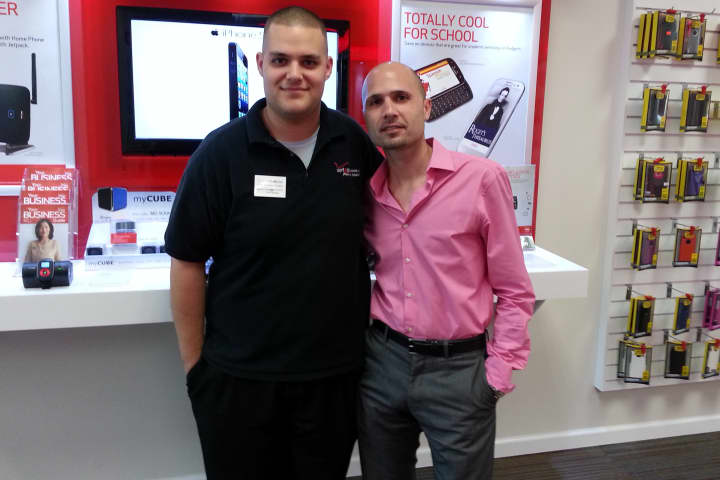 Eric Codella, left, store manager of Your Wireless Inc. in Stamford, meets Patrick Gesuele, New England sales director for the company.
